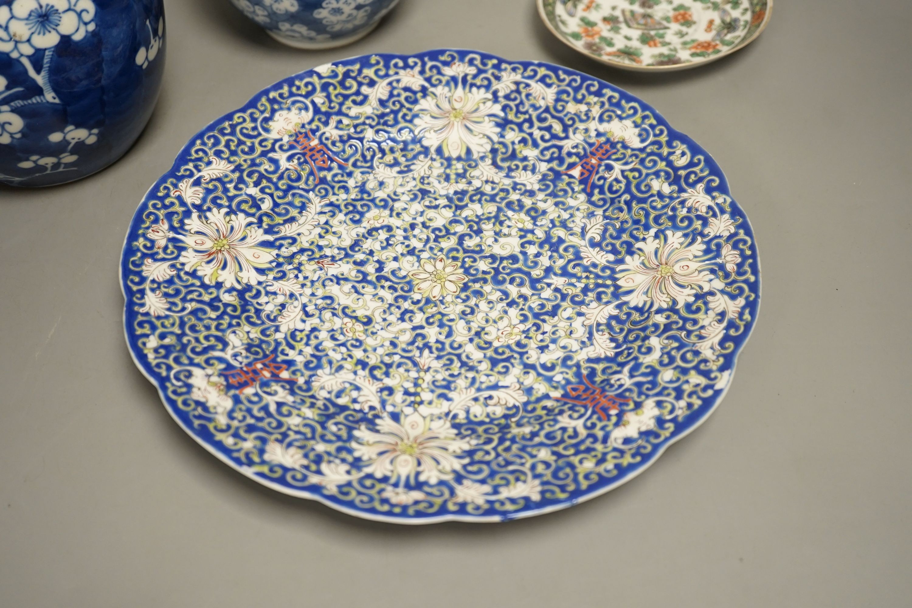 A Chinese blue and white jar, a similar vase, a polychrome plate and a famille verte saucer- plate 25 cms diameter.